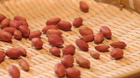 Fresh Red Skinned Peanuts Scattered on Woven Bamboo Mat Texture Vidéo 335498634
