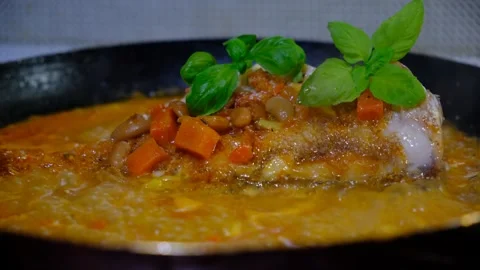 Fresh Red Snapper hot in the frying pan with carrot, garlic, basil, Stock Footage 334824036