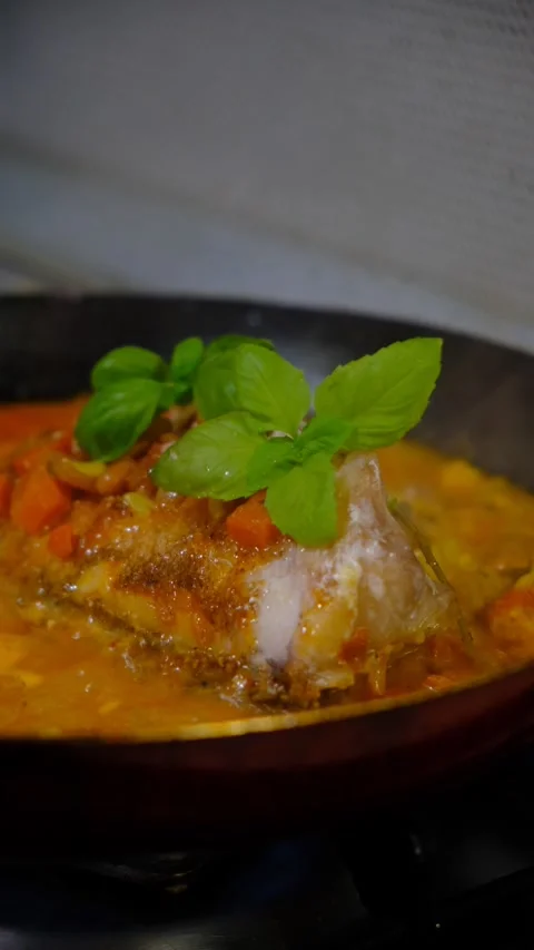 Fresh Red Snapper hot in the frying pan with carrot, garlic, basil,  savoury Stock Footage 334827700