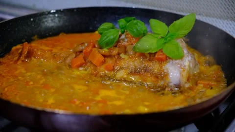 Fresh Red Snapper hot in the frying pan with carrot, garlic, basil,  savoury Stock Footage 334829459