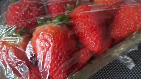 Fresh red strawberries inside plastic packaging Stock Footage 341904899