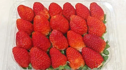 Fresh Red Strawberries in Plastic Container Stock Photos