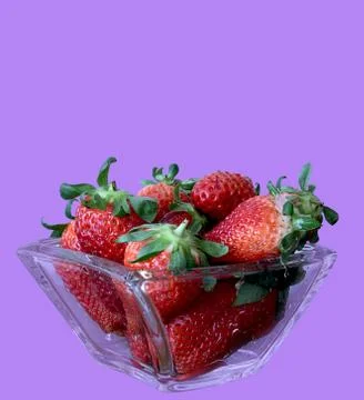 Fresh red strawberries on purple background Stock Photos
