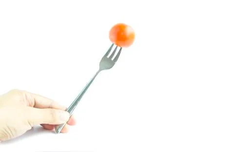 Fresh red tomato with fork by hand Stock Photos