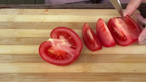 Fresh red tomato slices prepared on wooden cutting board and placed onto grill Stock Footage 345720854