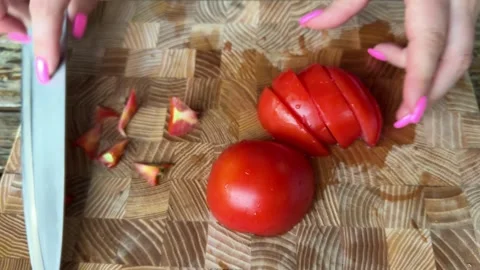 Fresh red tomato slices prepared on wooden cutting board and placed onto grill Stock Footage 345723955