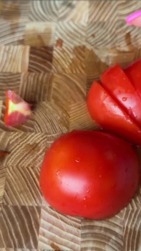 Fresh red tomato slices prepared on wooden cutting board and placed onto grill Stock Footage 345724695