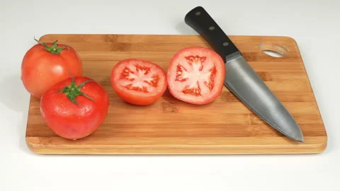 Fresh Red Tomatoes and Kitchen Knife on Wooden Board Stock Footage 342754718
