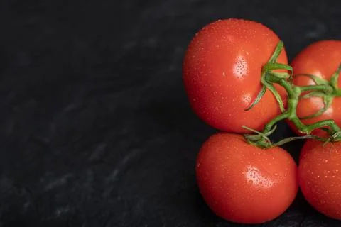 Fresh red tomatoes on dark background Stock Photos
