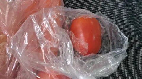 Fresh red tomatoes inside clear plastic grocery bag video footage animation Stock Footage 336276885