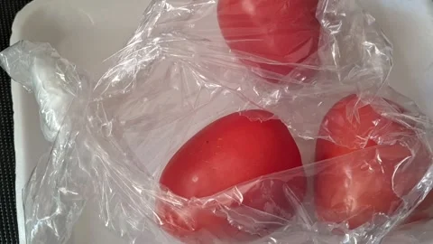 Fresh red tomatoes inside clear plastic packaging for video motion Stock Footage 339247451