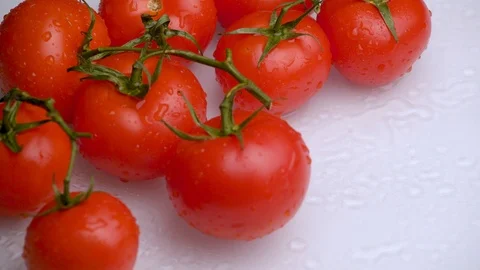 Fresh red tomatoes rotating on white background close-up. Video stock 115828762