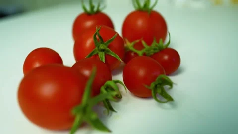 Fresh Red Tomatoes on White Surface, A close-up of fresh red tomatoes with .. Vídeos de archivo 304978808