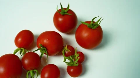 Fresh Red Tomatoes on White Surface, A close-up of fresh red tomatoes with .. Видео 304978810