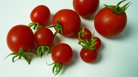 Fresh Red Tomatoes on White Surface, A close-up of fresh red tomatoes with .. Stock Footage 304978815