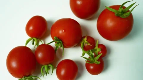 Fresh Red Tomatoes on White Surface, A close-up of fresh red tomatoes with .. Vídeos de archivo 304978896