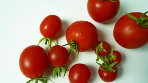 Fresh Red Tomatoes on White Surface, A close-up of fresh red tomatoes with .. Vídeos de archivo 304978903