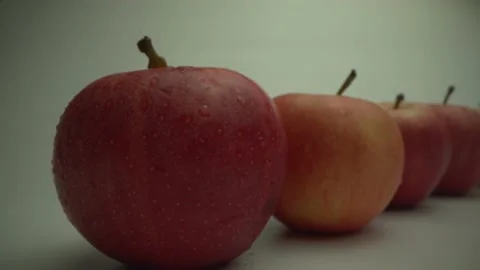 Fresh ripe apples on a white table. Macro shot from Laowa 24 mm Probe lens Stock Footage 134700941