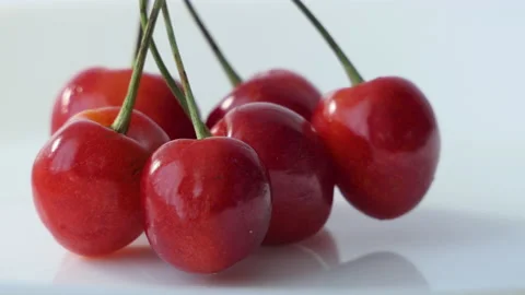 Fresh ripe Cherry close-up. Rotated Organic red cherries isolated on white Stock Footage 201198791