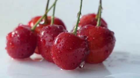 Fresh ripe Cherry close-up. Rotated Organic red cherries isolated on white Stock Footage 201552207