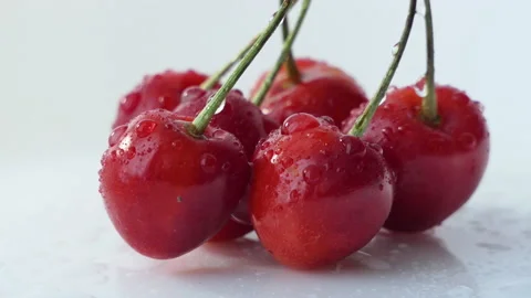 Fresh ripe Cherry close-up. Rotated Organic red cherries isolated on white Stock Footage 201884814