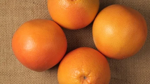 Fresh ripe grapefruits rotating on burlap Stock Footage 344915393