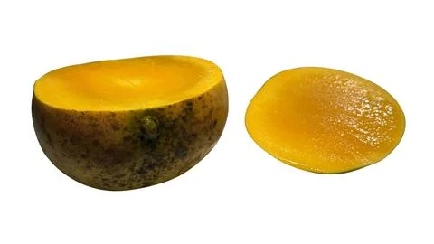 Fresh ripe mango cut in half with a separate juicy slice Stock Photos