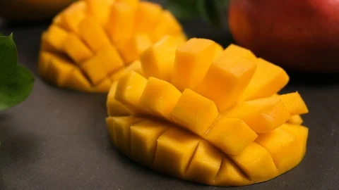 Fresh Ripe Mango Fruit Halved And Cut Into Cubes Video stock 128233642