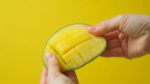 Fresh Ripe Mango Half Cut into Cubes in Human Hands Stock Footage 328010165