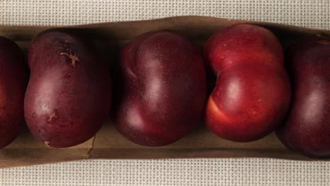 Fresh ripe nectarines moving in a row Stock Footage 344915438
