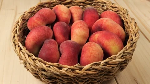 Fresh ripe peaches rotating in a wicker basket Stock Footage 338312326