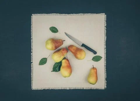 Fresh ripe pears on light rustic napkin. Cooking pear pie. Knife and ripe f.. Stock Photos