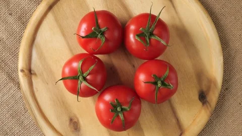 Fresh ripe red tomatoes rotating on wooden board Stock-Footage 338312362
