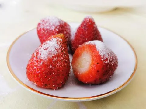Fresh ripe strawberries in a simple white bowl, on wood table Stock Photos