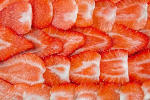 Fresh ripe strawberry pattern. Texture of sliced strawberries. Stock Photos