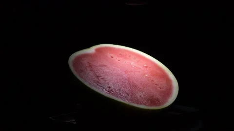 Fresh Ripe Watermelon Half Rotating Slowly on Black Background 動画素材 341981544