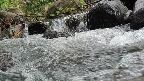 Fresh River Water Flowing Between Rocks in Natural Setting Stock Footage 330332098