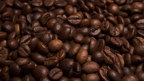Fresh roasted brown coffee beans, close up rotating shot in slow motion Stock Footage 116527041