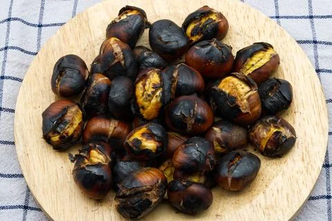 Fresh roasted chestnuts on a table. Top view Stock Photos