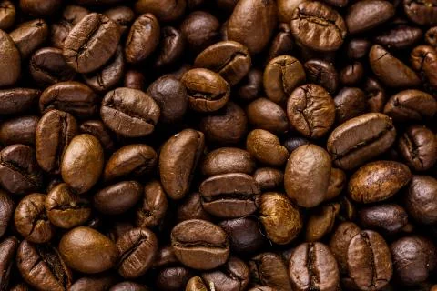 Fresh roasted coffee bean background. Background of roasted coffee beans, top Stock Photos