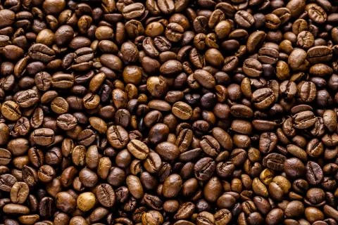 Fresh roasted coffee bean background. Background of roasted coffee beans, top Stock Photos