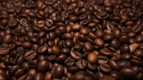 Fresh roasted coffee beans close up, falling from above. Slow zoom in Stock Footage 116528601