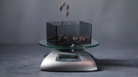 Fresh roasted coffee beans falling to scales Stock Footage 168571375
