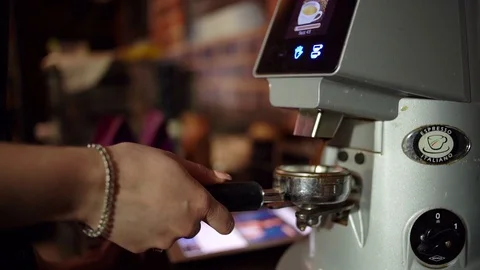 Fresh roasted coffee beans pouring in a grinder. Video stock 106389150