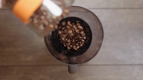 Fresh roasted coffee beans pouring in grinder from jar. Preparing coffee. Stock Footage 112681254