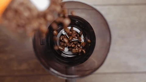 Fresh roasted coffee beans pouring in grinder from jar. Preparing coffee. Stock Footage 112681288