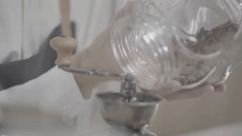 Fresh roasted coffee beans pouring in a grinder from glass jar Stock Footage 120492284