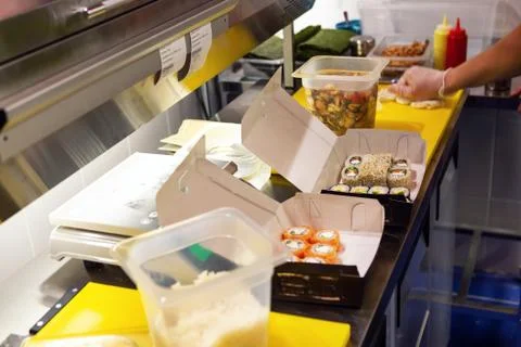 Fresh roll sets packed in boxes on the table Stock Photos