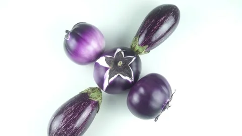 Fresh Round And Striped Eggplants Rotate On A Clean White Background. Stock Footage 340609223