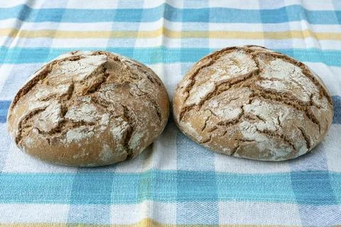 Fresh rustic bread on a checkered towel 스톡 사진